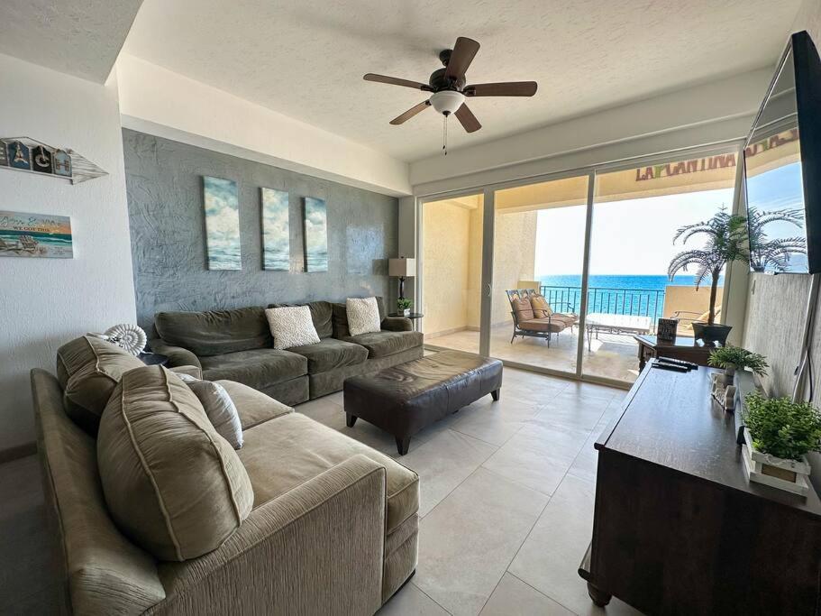 a living room with a couch and a ceiling fan at Family friendly Condo with Oceanfront Views in Puerto Peñasco