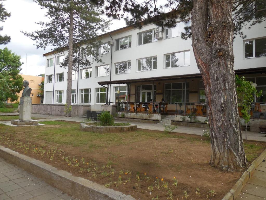 a white building with a tree in front of it at Комплекс Маджарово in Madzharovo