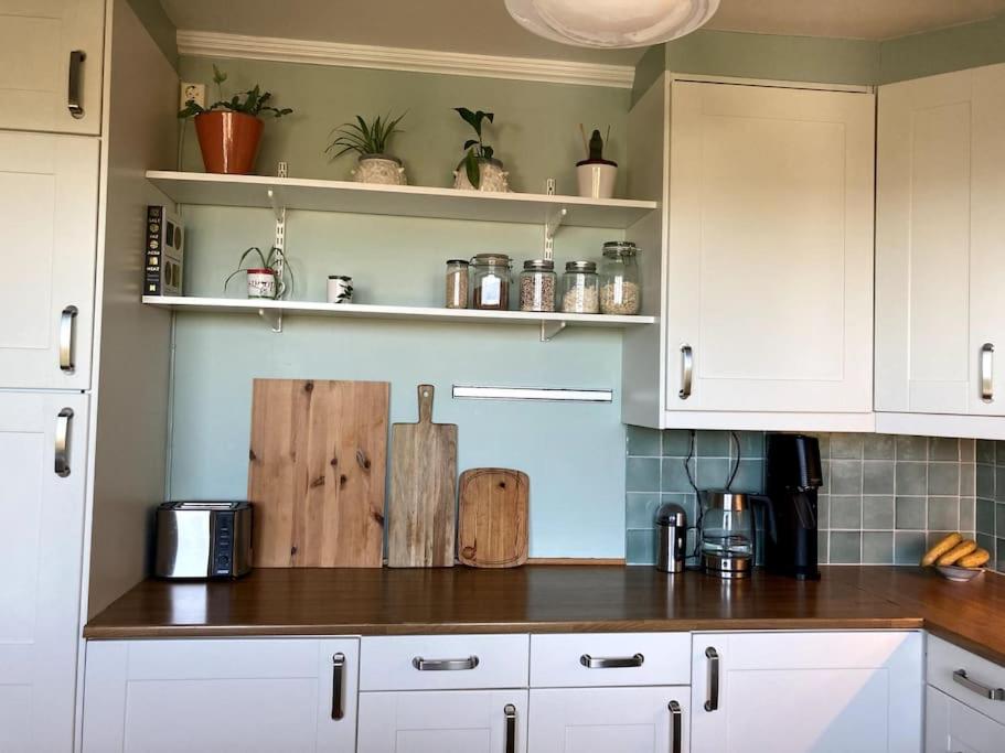 a kitchen with white cabinets and a counter top at The best view in Oslo in Oslo