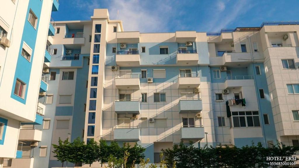 a tall building with balconies on the side of it at Hotel Ersi in Shëngjin