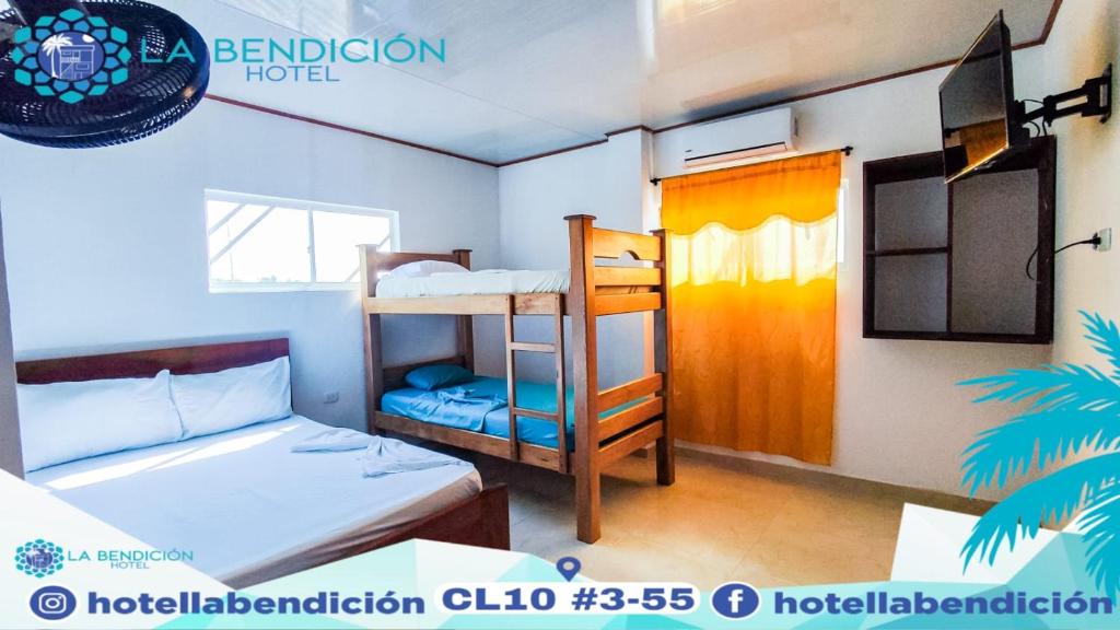 a dorm room with two bunk beds and a window at Hotel la Bendición in Moñitos