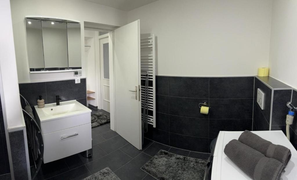 a bathroom with a sink and a mirror at Apartment Deluxe Rosenheim Top 2 