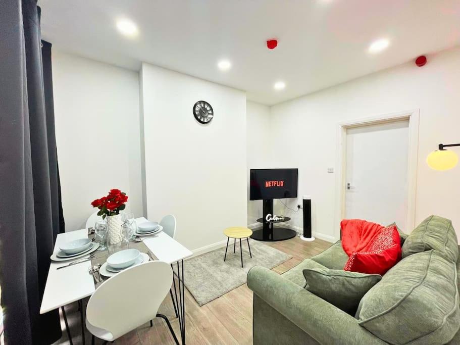a living room with a couch and a table at Crimson Apartment - Lovely Flat in Leicester in Leicester