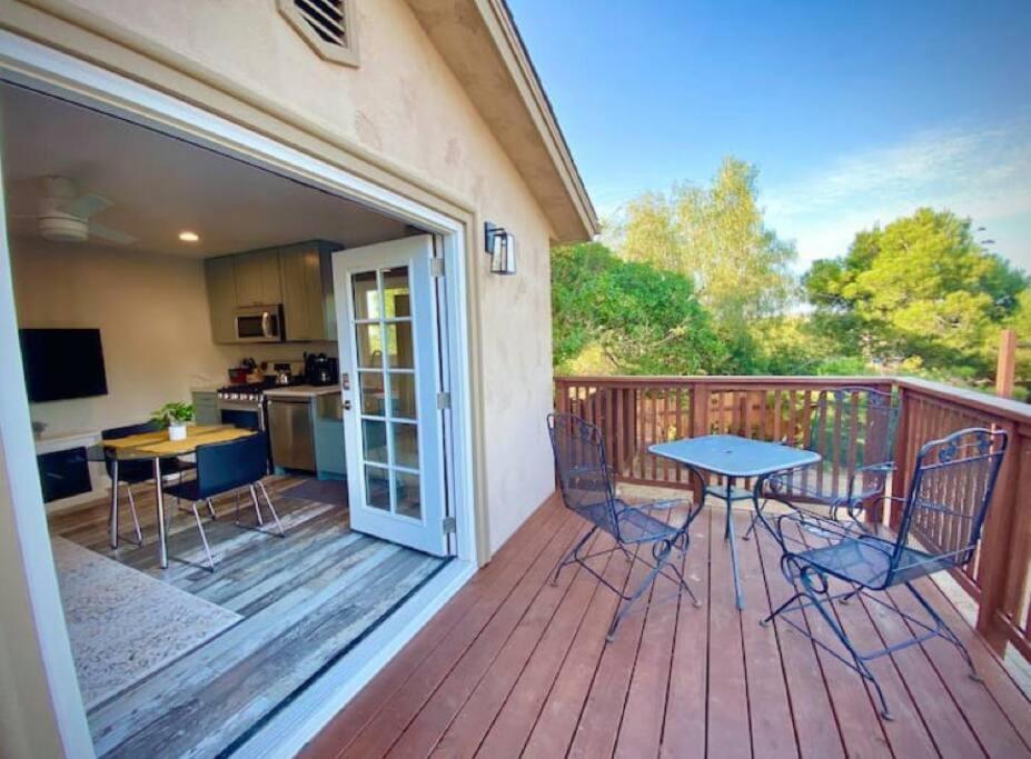 a patio with a table and chairs on a deck at One bedroom retreat full kitchen/laundry 1GB Wi-Fi in Bonita