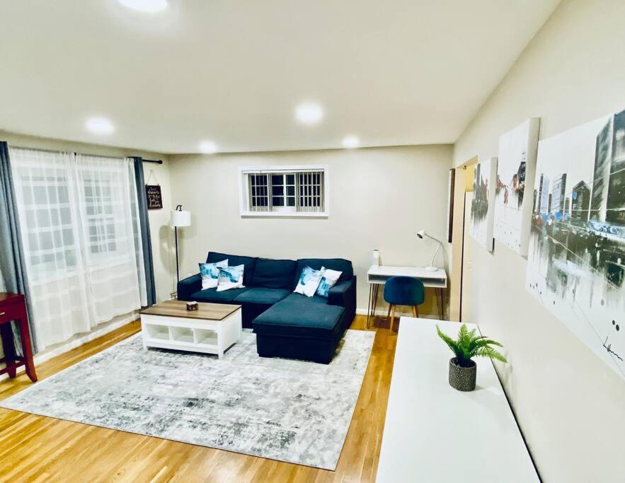 a living room with a blue couch and a table at North Bethesda Gem in Rockville