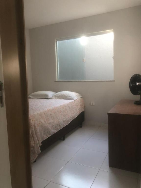 a bedroom with a bed and a large mirror at Aconchego in Aracaju