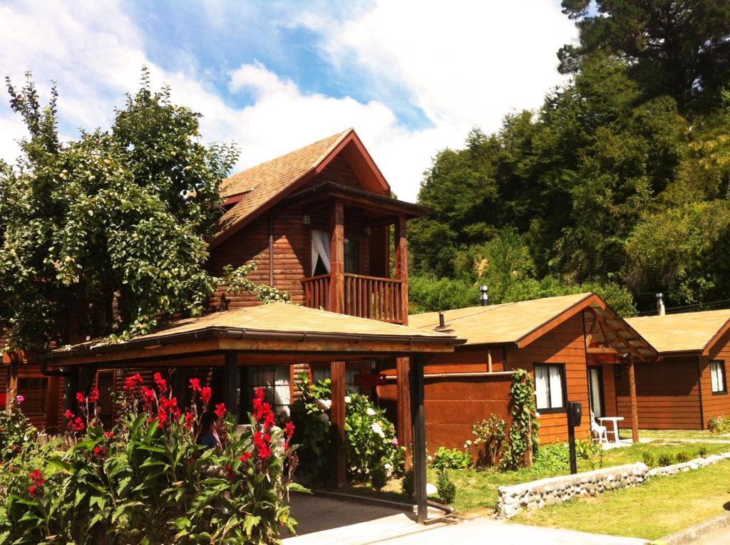 a log cabin with a porch and a deck at Cabañas del Teatro Frutillar in Frutillar