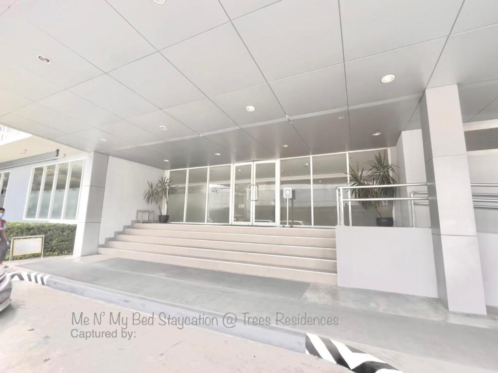 a lobby of a building with stairs and windows at Me N’ My Bed Staycation @ SMDC Trees Residences in Manila