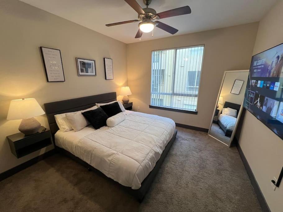 1 dormitorio con 1 cama y ventilador de techo en Luxury Modern Condo 3-min from Six Flags w/PS5, 1GB Fast Wi-fi Kingbed, en Santa Clarita