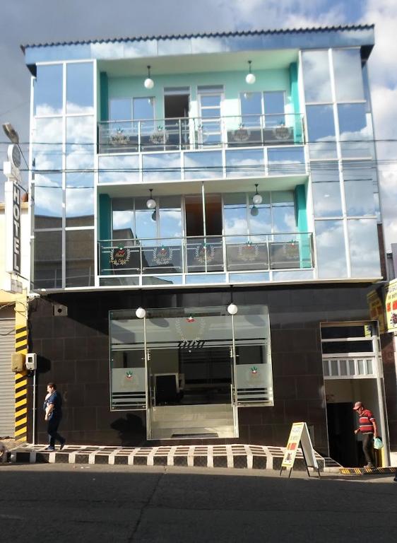 a large building with a balcony on the side of it at Hotel El Jardín Cafetero Armenia in Armenia