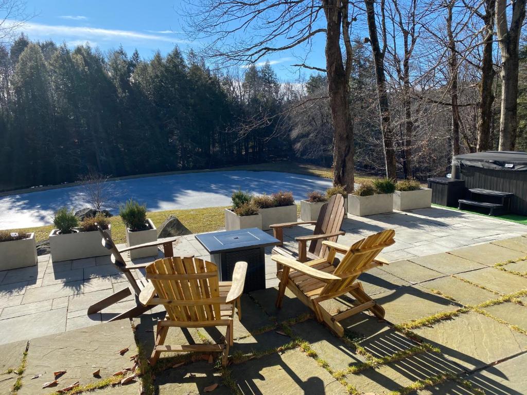 a patio with two chairs and a table at Catskills Pond Getaway in Liberty