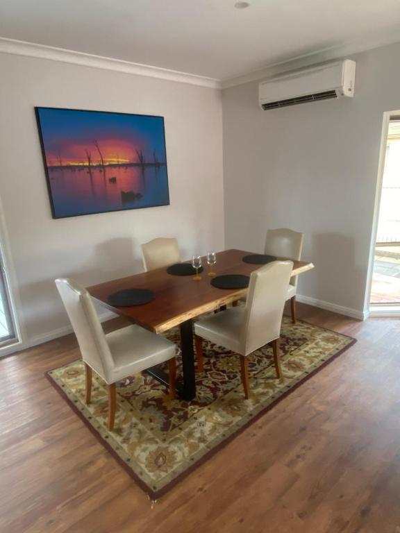 a dining room with a wooden table and chairs at Central Yarrawonga in Yarrawonga