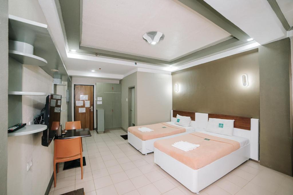 Postel nebo postele na pokoji v ubytování GC Hotel