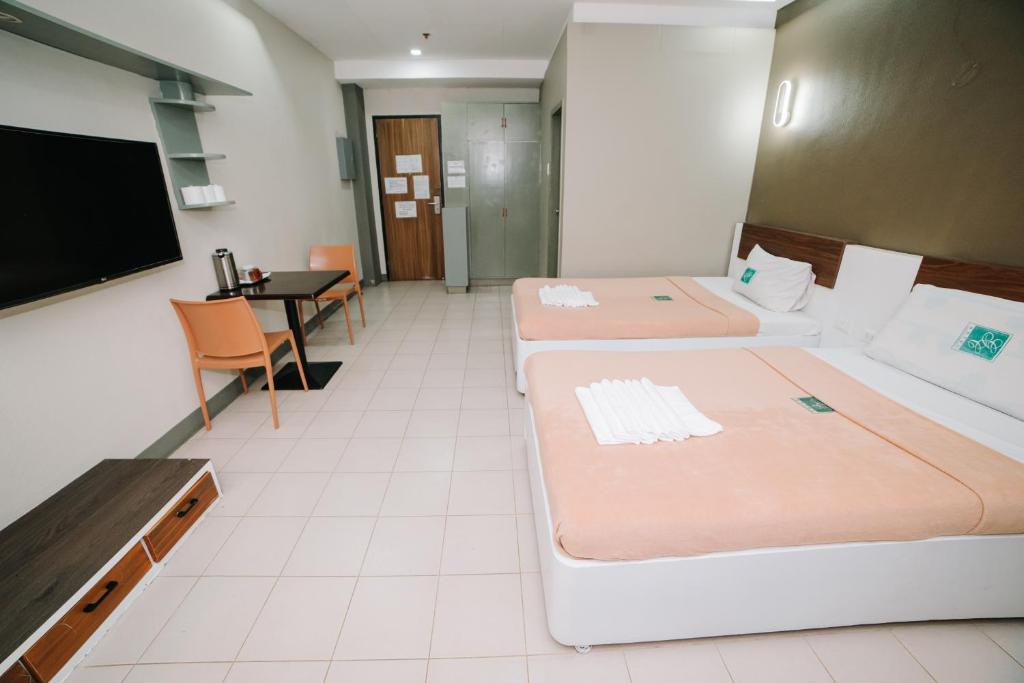 Postel nebo postele na pokoji v ubytování GC Hotel