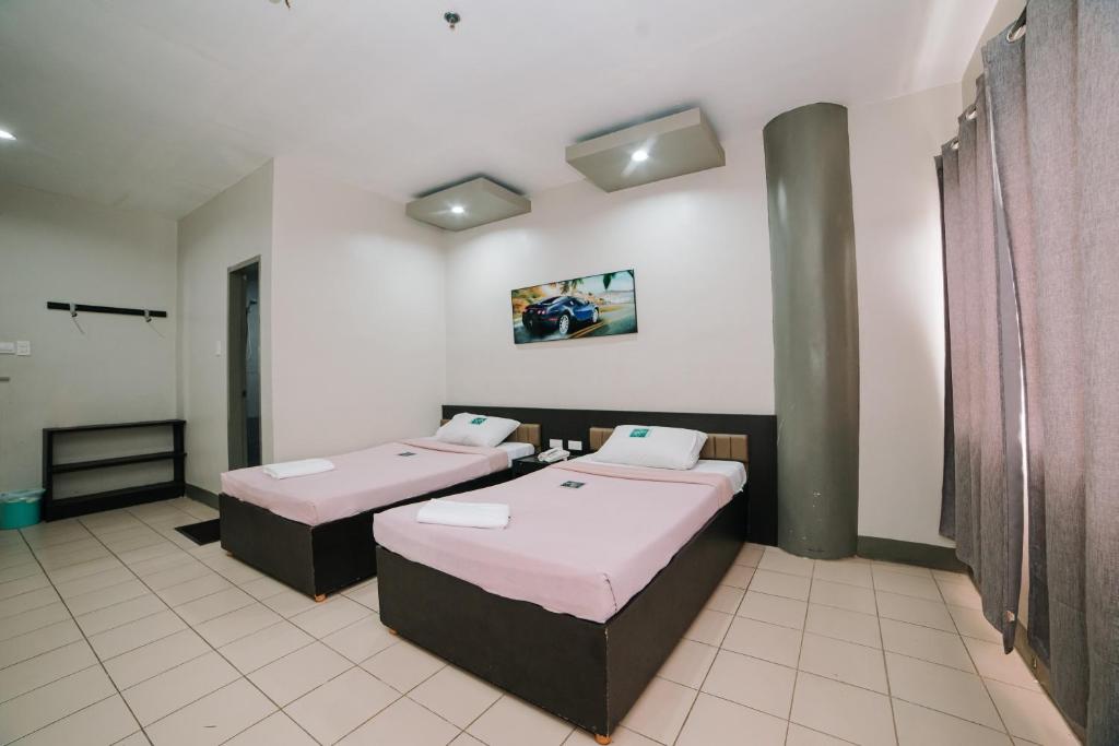 Postel nebo postele na pokoji v ubytování GC Hotel