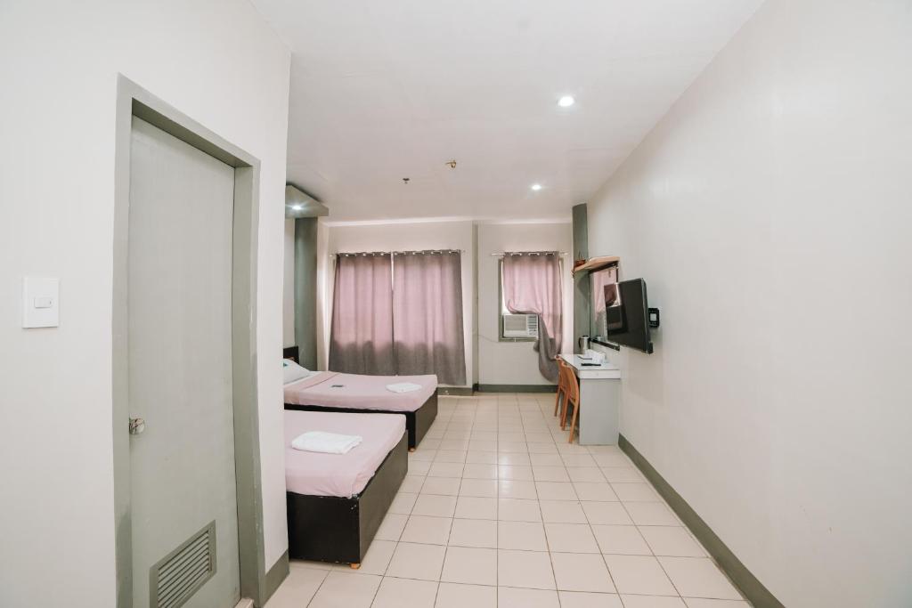 Postel nebo postele na pokoji v ubytování GC Hotel