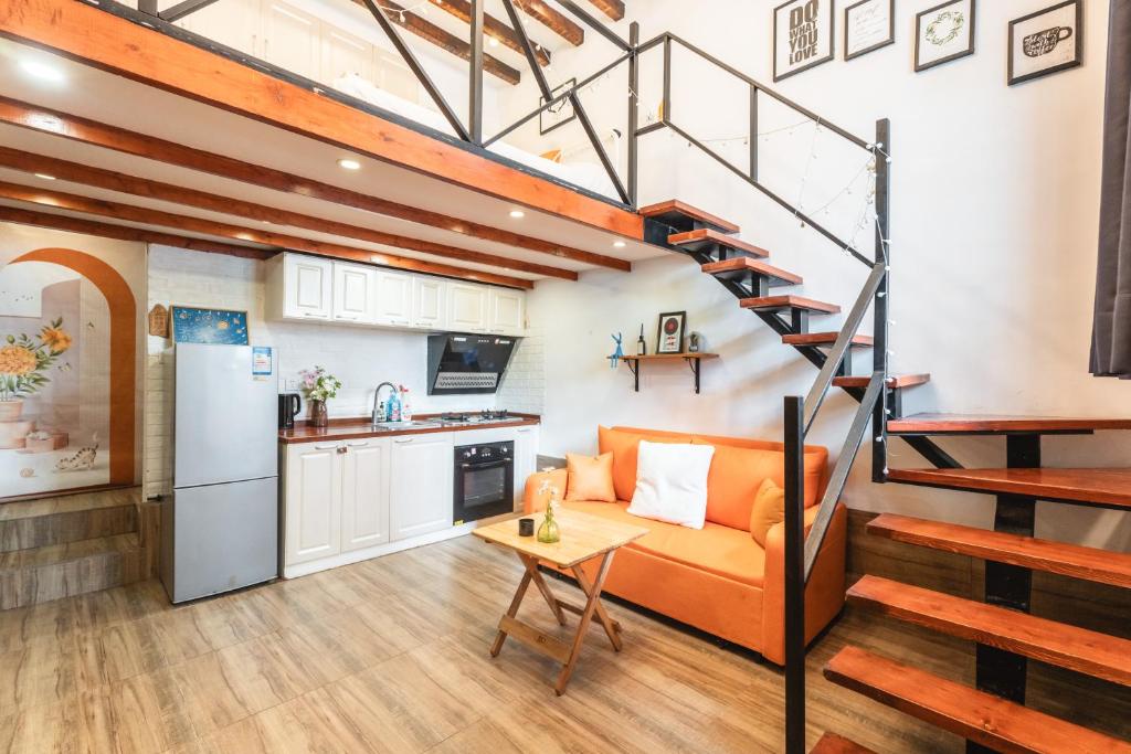 a living room with an orange couch and a spiral staircase at Shanghai Hills&XING 4456 Homestay in Shanghai