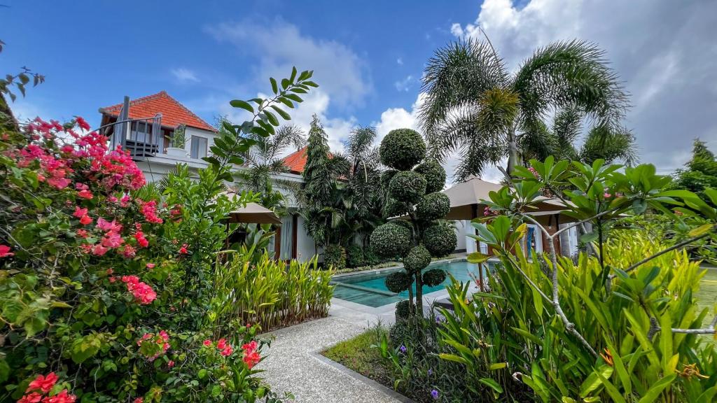 a house with a garden and a swimming pool at Green Valley Lombok in Selong Belanak