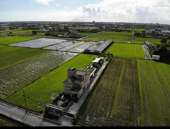 an aerial view of a house in a field at After the Court Chiaohsi in Jiaoxi