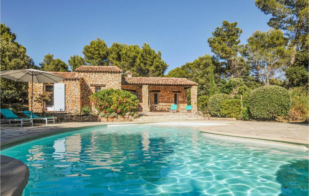 a swimming pool in front of a house at 6 Bedroom Stunning Home In Aups in Aups