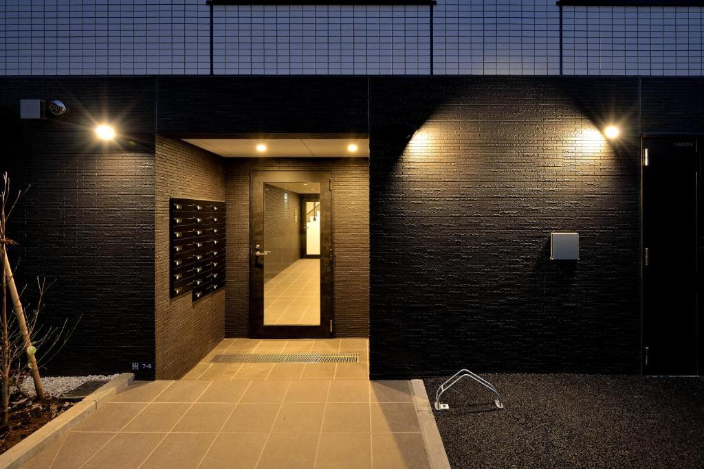 a hallway of a building at night with a mirror at Hostel Inn Tokyo Asakusa East in Tokyo