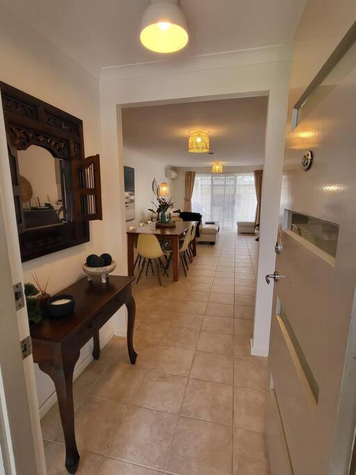 a hallway with a table and a living room at Villa Cinta @Cape View Resort in Broadwater