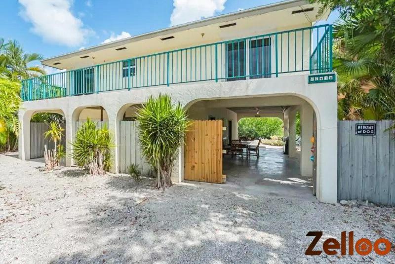 a house with a balcony and a patio at Experience Coastal Living at its Best Florida Keys in Summerland Key