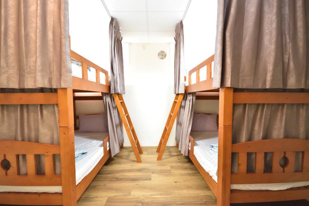 a couple of bunk beds in a room at Dongjin B&B in Taimali