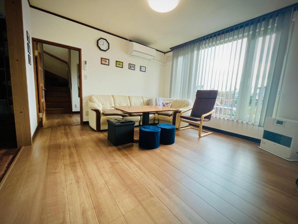 een woonkamer met een bank en een tafel bij Lavie plus in Noboribetsu