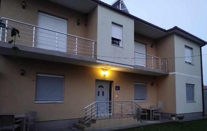a house with a balcony with a light on it at Vila Snezana in Gevgelija