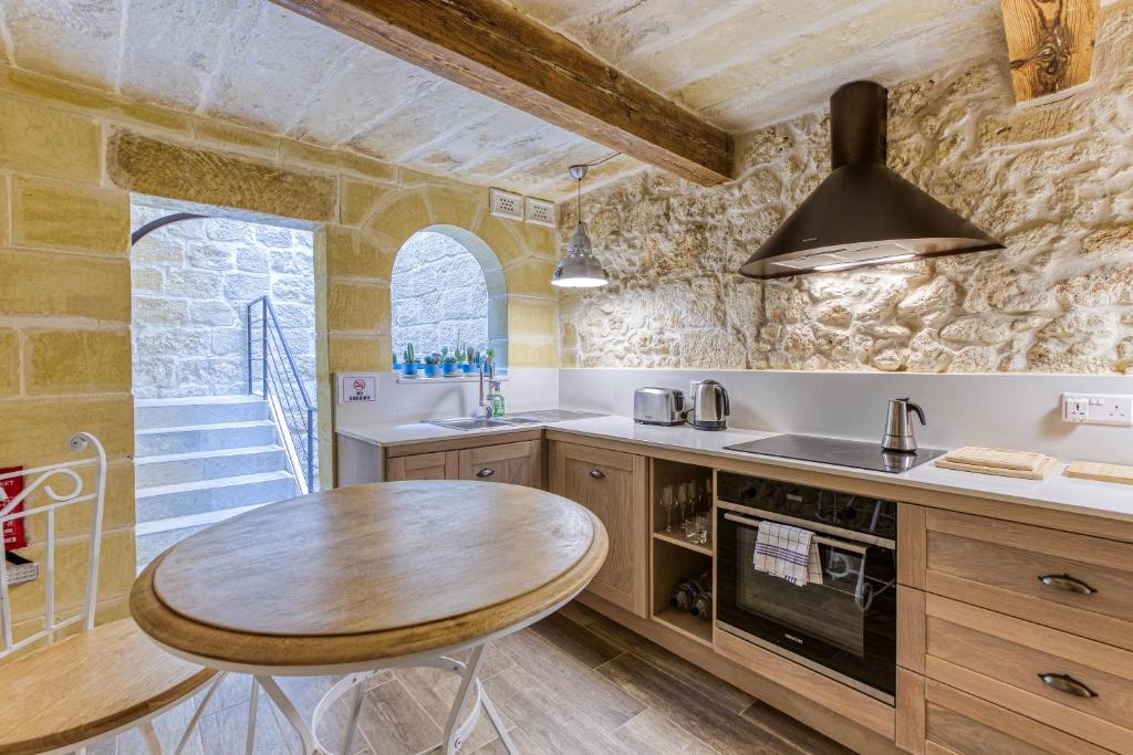 a kitchen with a wooden table and a dining room at Rb42 - Charming & Historic House in Rabat