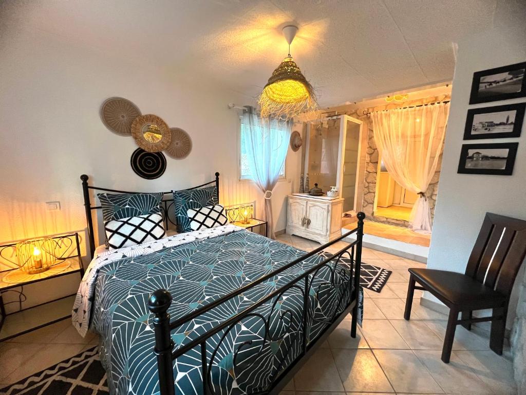 a bedroom with a bed with a blue comforter at Villa Conception in Le Thoronet