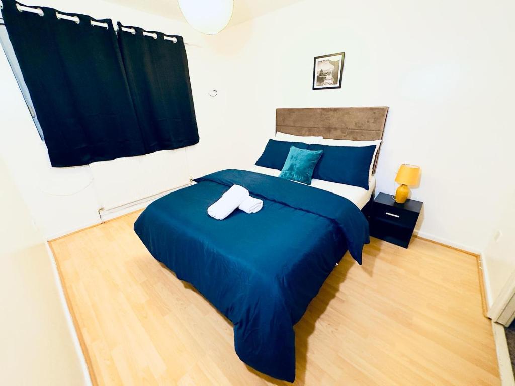 Un dormitorio con una cama azul con dos cruces. en Home Paradise Manchester- 3 Bedroom House en Mánchester