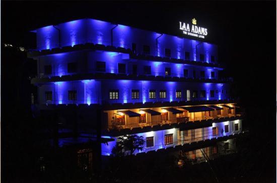 a lit up building with blue lights on it at Laa Adams - The Luxurious Living in Hatton