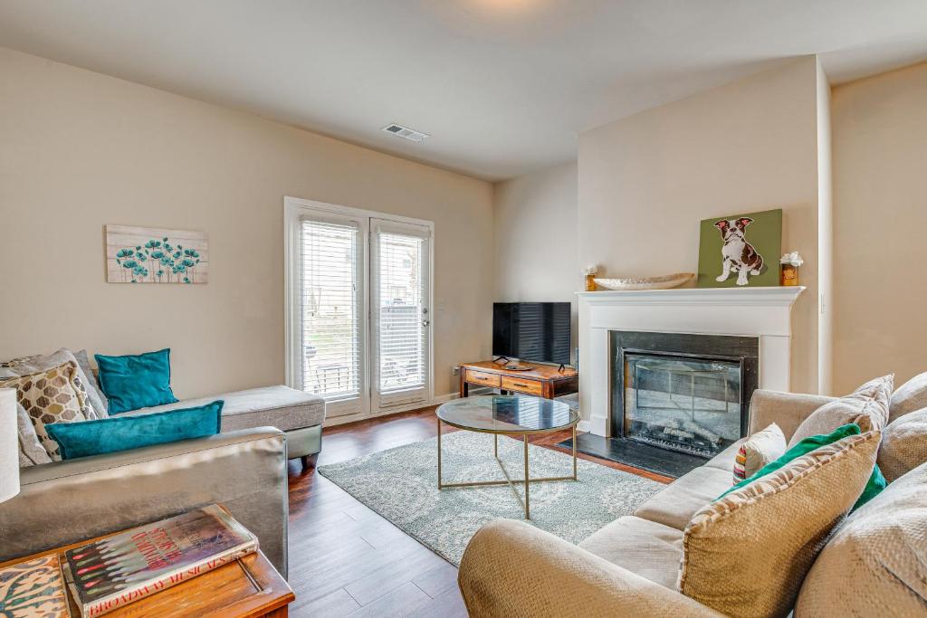 a living room with a couch and a fireplace at Spacious Atlanta Home with Yard and Charcoal Grill! in Atlanta