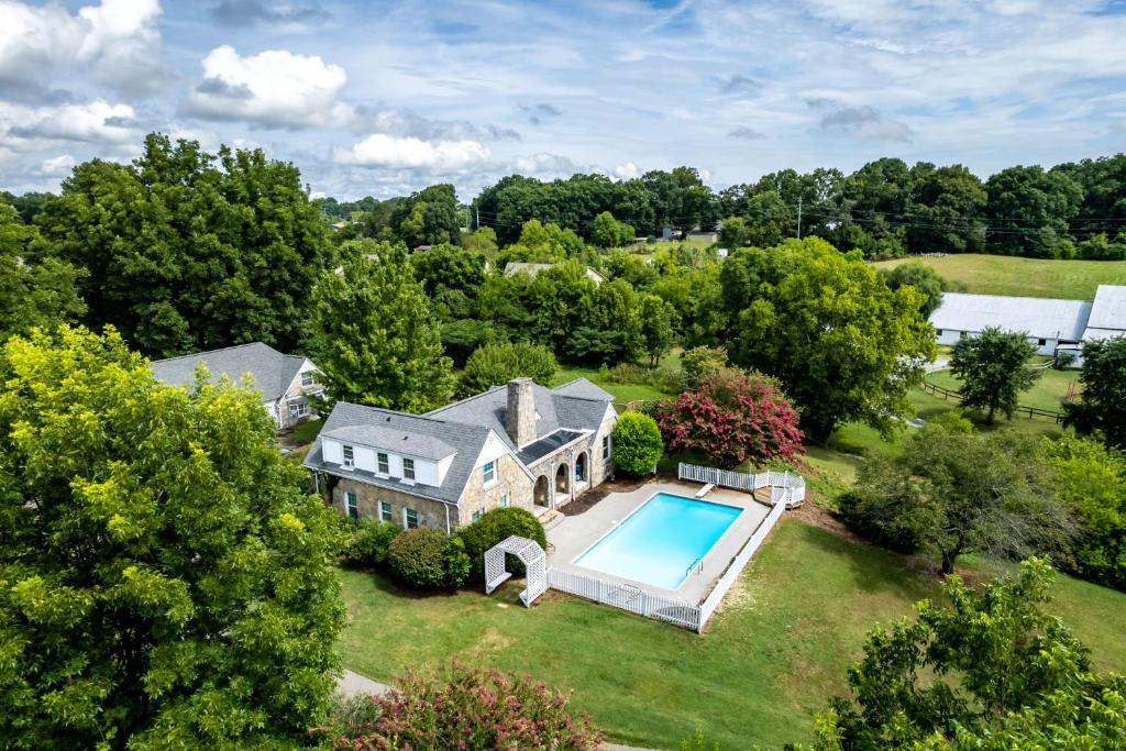 an aerial view of a house with a swimming pool at Tranquil Mountain Escape Luxurious 5-Bedroom Farmhouse with Pool in Maryville