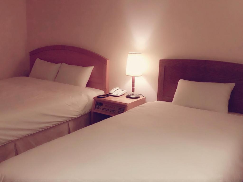 Postel nebo postele na pokoji v ubytování Daedong Hotel