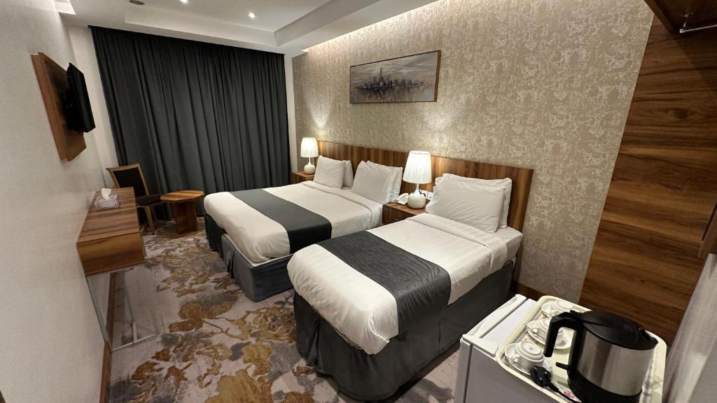 Postel nebo postele na pokoji v ubytování Multazam Al-Nnaseem Hotel