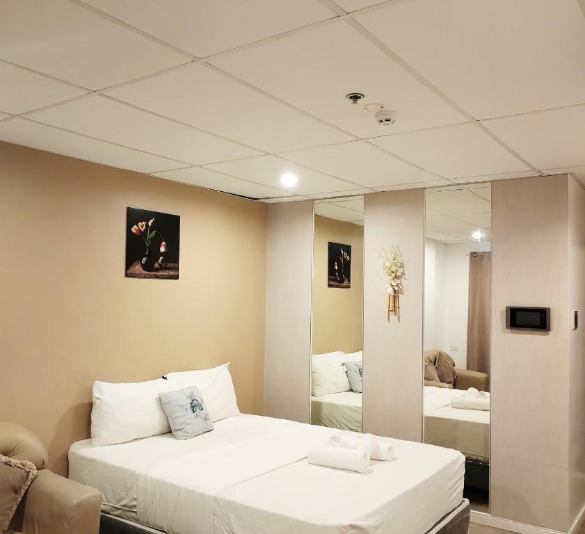 Pokój z 2 łóżkami i lustrem w obiekcie Smart Condominium Official w mieście Cagayan de Oro