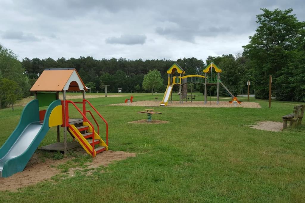 a park with a playground with slides and a slideintend at Tipi Apache des monteaux in Vivy
