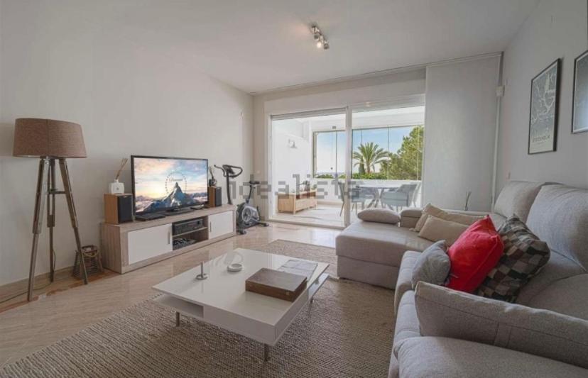 a living room with a couch and a tv at Moderno Loft - Beach & Golf in Marbella
