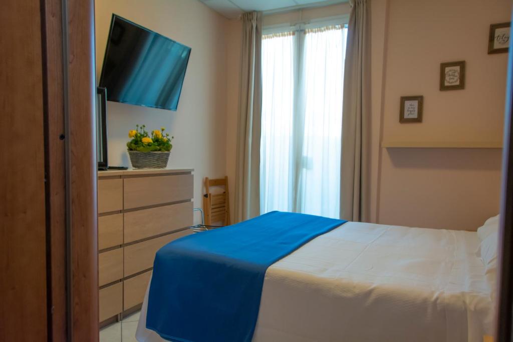 A bed or beds in a room at Hotel Delle Mimose
