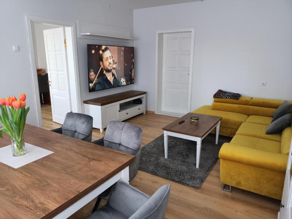 een woonkamer met een bank en een tv bij Klaipeda,Lithuania in Klaipėda
