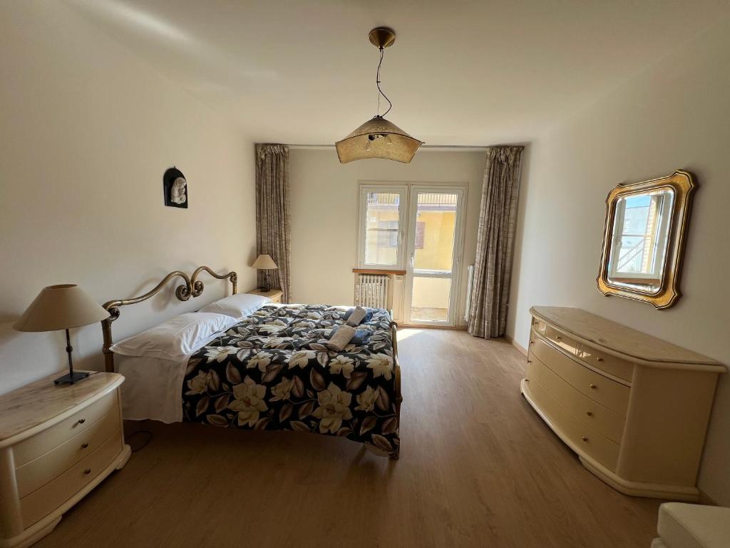 um quarto com uma cama, uma cómoda e uma janela em Casa Mattioli em Mombaroccio