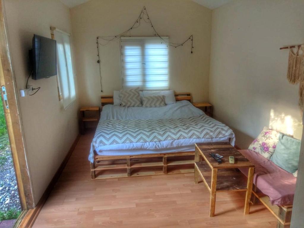 - une petite chambre avec un lit et une table dans l'établissement Köklü Ahşap Tatil Evleri, à Antalya