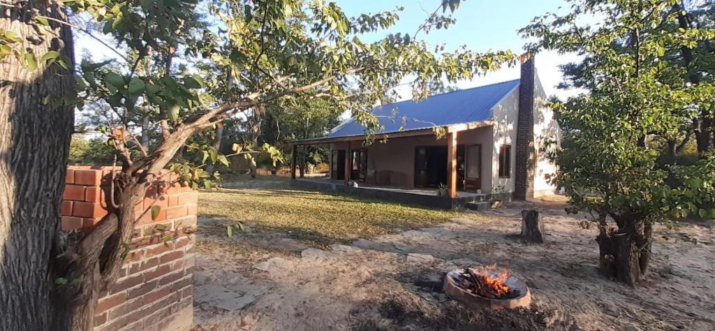 a house with a fire pit in front of it at Adansonia Farm 