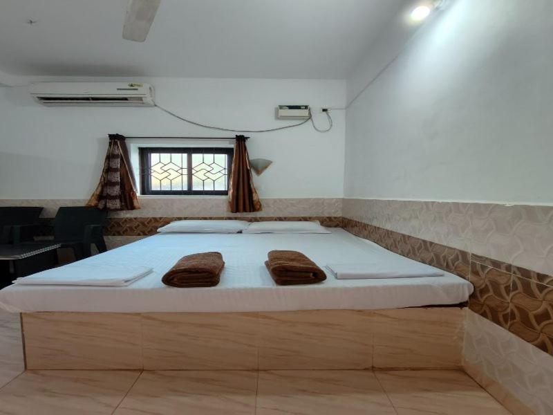 a bedroom with a bed with two towels on it at LEON HOME STAY in Bogmolo