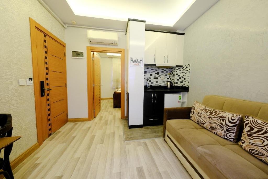 a living room with a couch and a kitchen at Taksim Celebi Suites in Istanbul