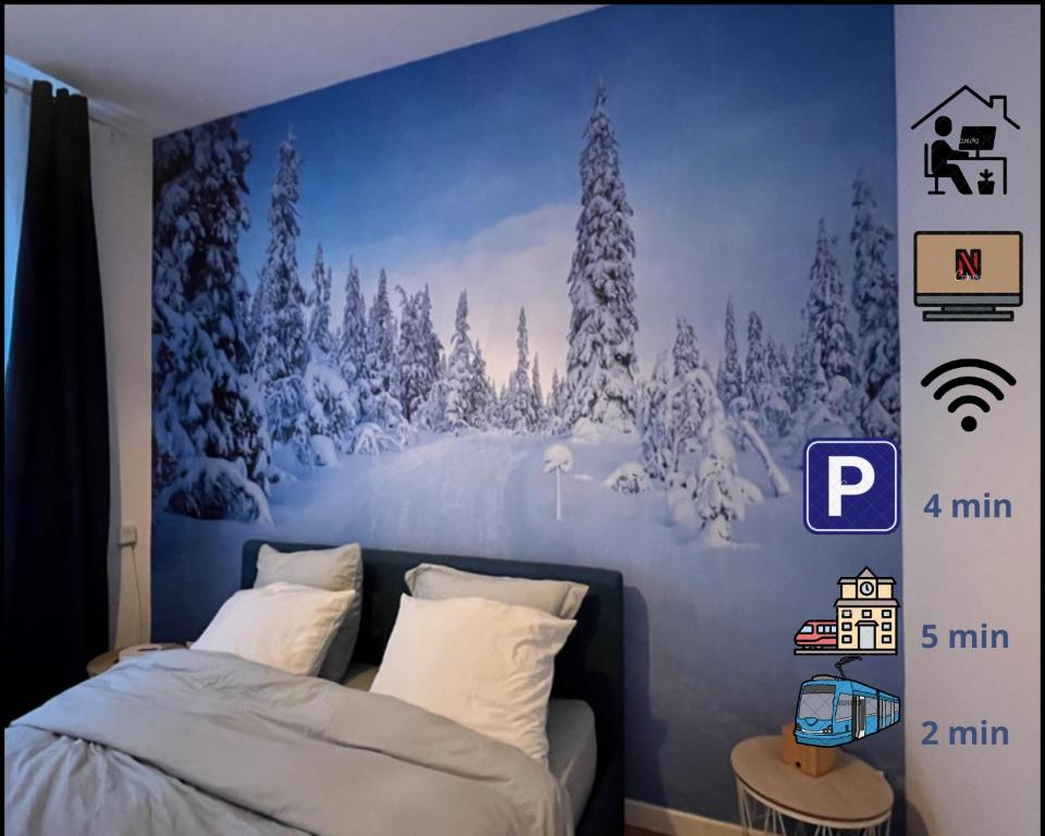 Suite Cosy MontBlanc en Hyper Centre في فالنسيان: غرفة نوم بجدار ازرق مع جدارية شجرة مغطاة بالثلج