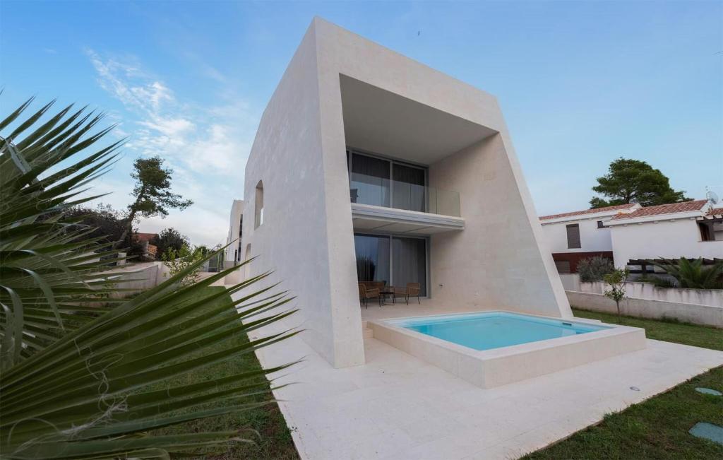 a house with a swimming pool in front of it at 4 Bedroom Beautiful Home In Petrcane in Petrcane